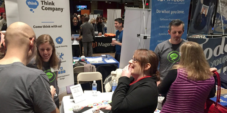 Photo of Think Company employees at job fair table