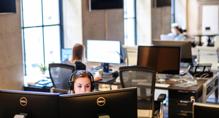 UX Engineer working at a desktop computer