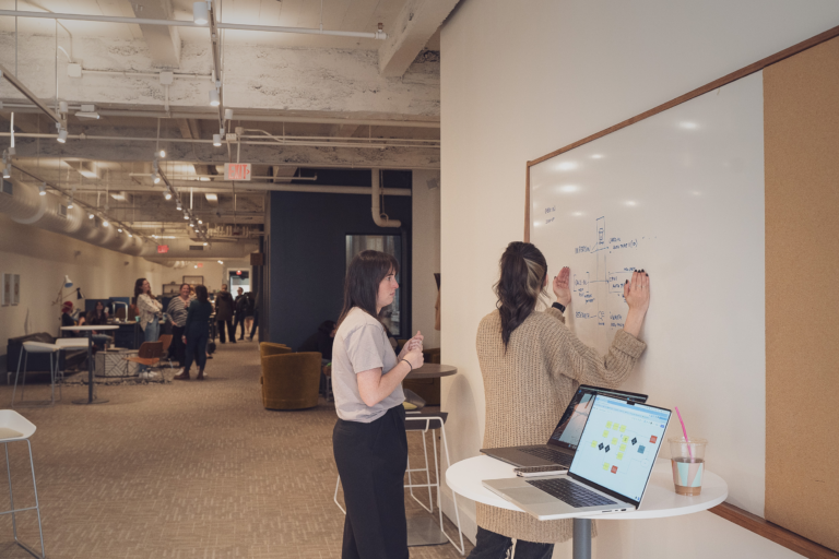 Strategists working on a whiteboard