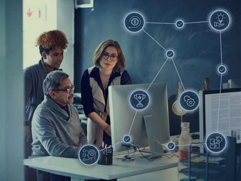 People working around a computer with icons overlaid