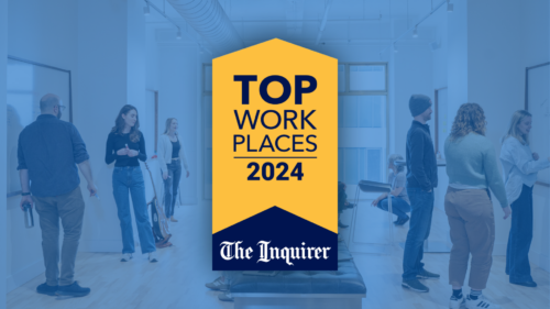 Thinkers collaborating with a Philly Inquirer Top Workplace badge